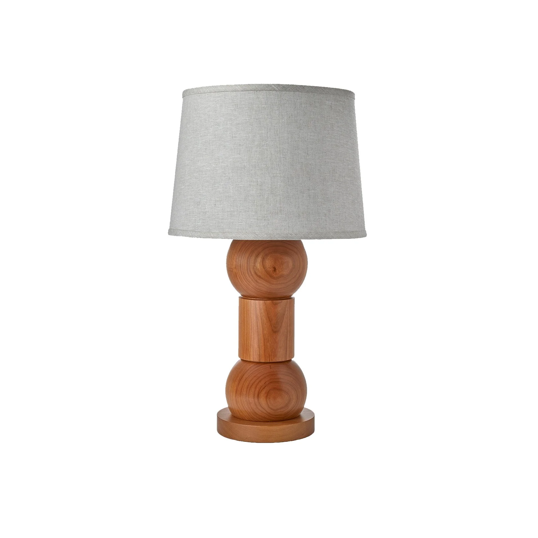 The Orion Lamp is a made-to-order solid hardwood lamp from O&G Studio, shown here in natural cherry wood