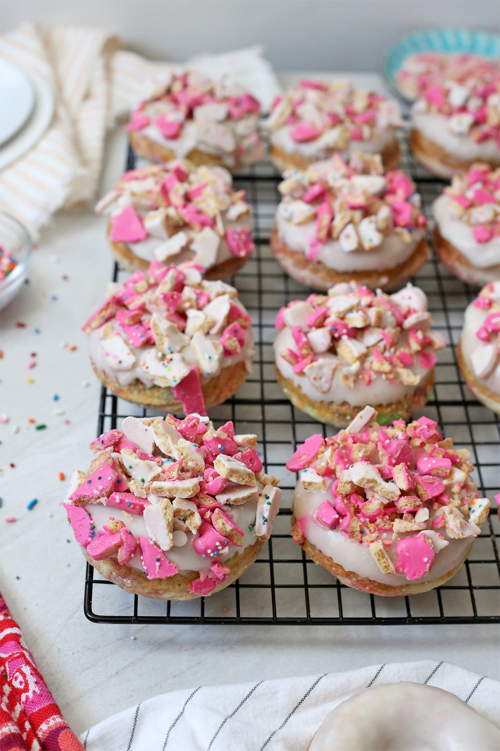 Funfetti Donuts topped with vanilla glaze and Frosted Animal Crackers. Unusuallylovely.com