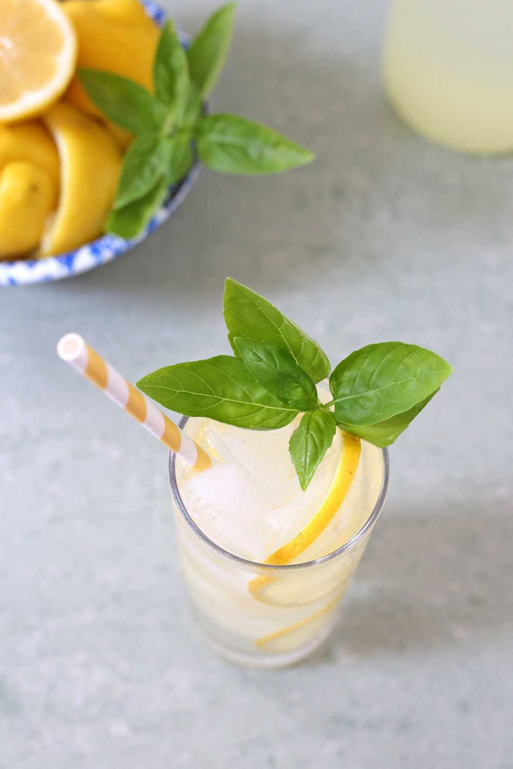 Homemade Lemonade infused with basil and topped with vodka and sparkling water. The perfect summer drink! Recipe: Unusuallylovely.com