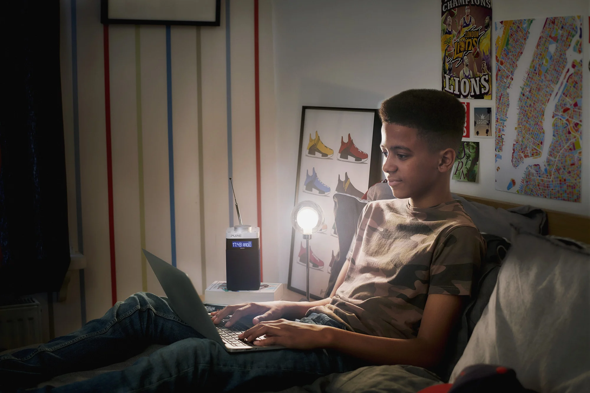 teenager doing homework on bed