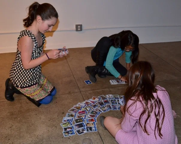 Young girls playing with WINGS trading cards