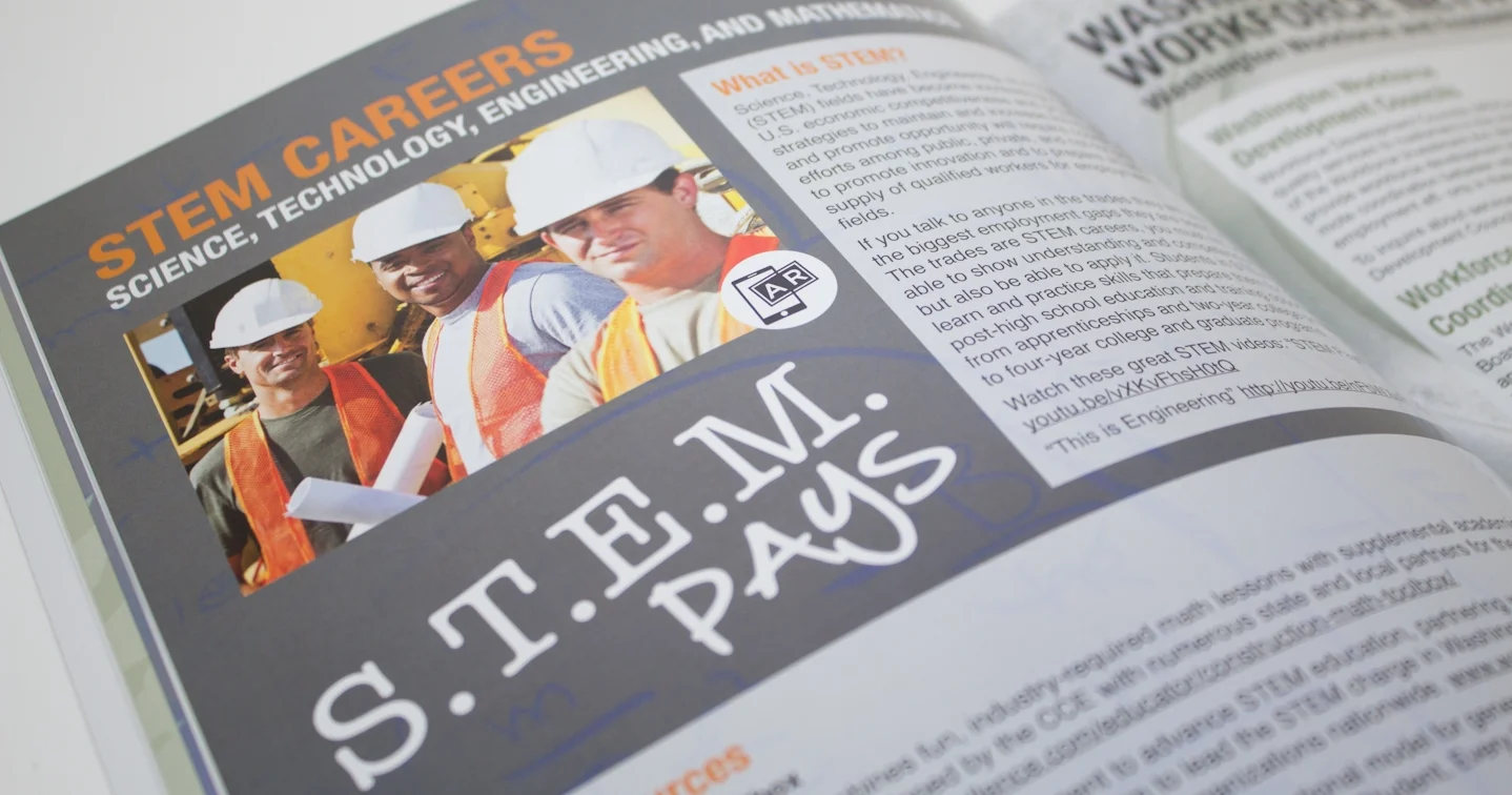 Scanning the photo on the Construction Center of Excellence student handbook with a mobile device brings up digital imagery layered over the real-world page.