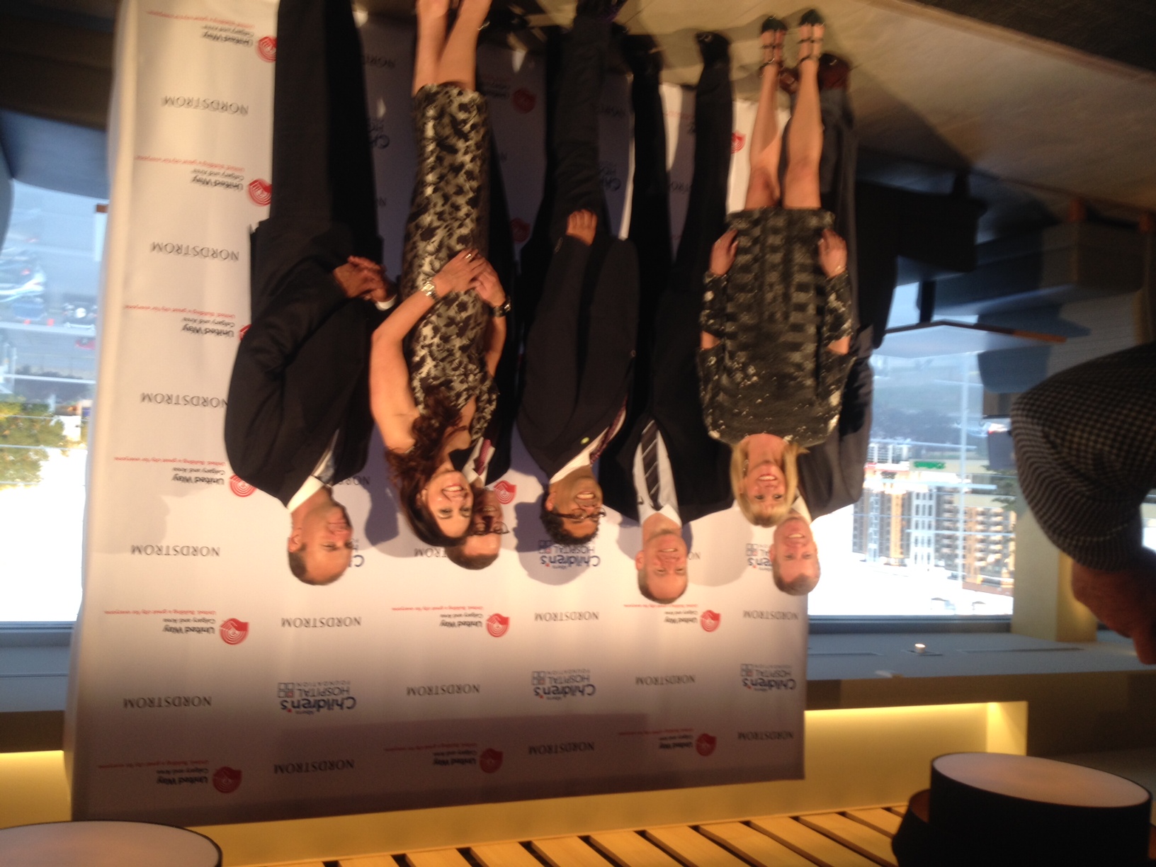 Members of the Nordstrom family as well as Nordstrom's Canadian President Karen McKibben (dark hair), store manager Shelia Wooldridge (blonde hair), and at the centre, Calgary mayor Naheed Nenshi.