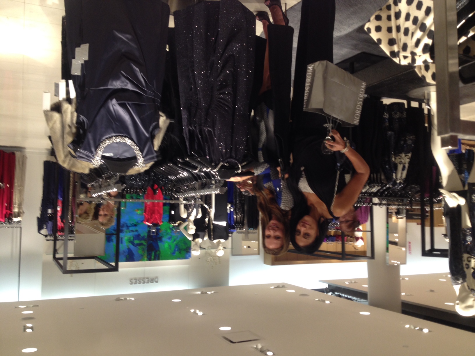 Two lovely ladies shop in the store's dress department. 