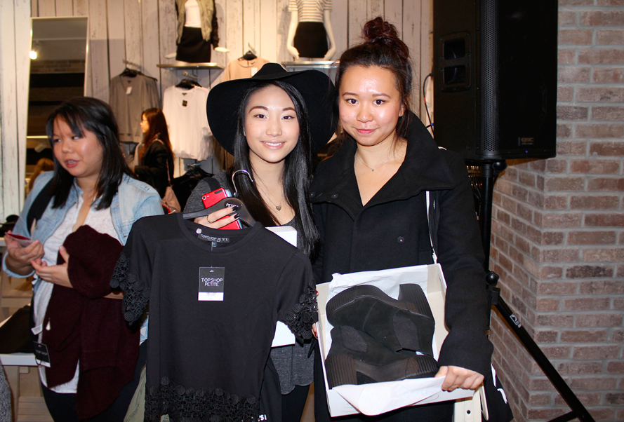 Samantha Luk and Sally Poon show off their purchases at the TOPSHOP store opening - black lace panel tee , floppy wool fedora hat and black HOLA Suede Chelsea Boots .