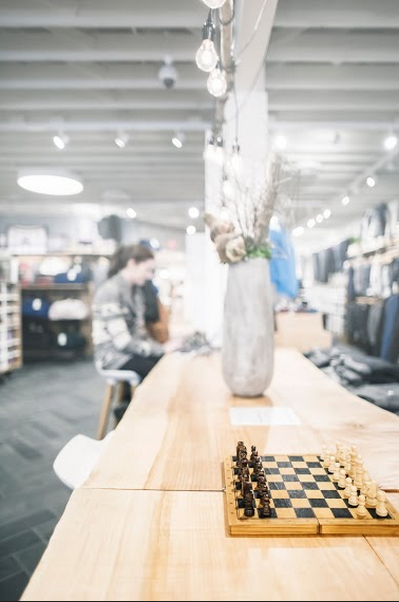 Movable 'collective tables' of thick Western Maple at the centre of the store, designed by Alison Janzen, fabricated by Peregrine. Photo: Nicholas Yee.