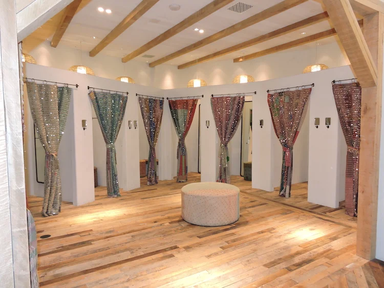 8 fitting rooms feature distinctive wall finishes, including mica plaster, white washed beadboard, and suede wash further lend to the 'workshop theme'.