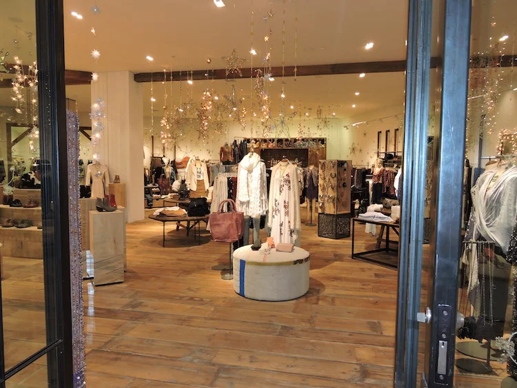 Reclaimed wide plank wood floors encompass the main sales floor in the new CF Sherway Gardens store. 