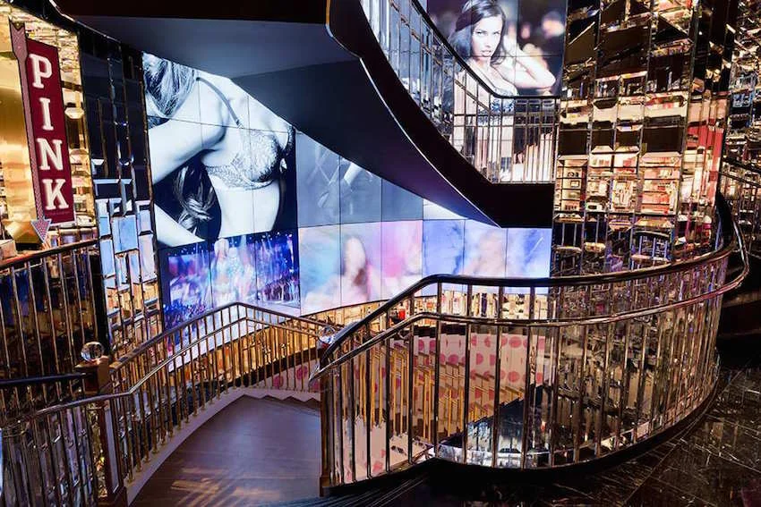 Marble and glass stairway and video screens