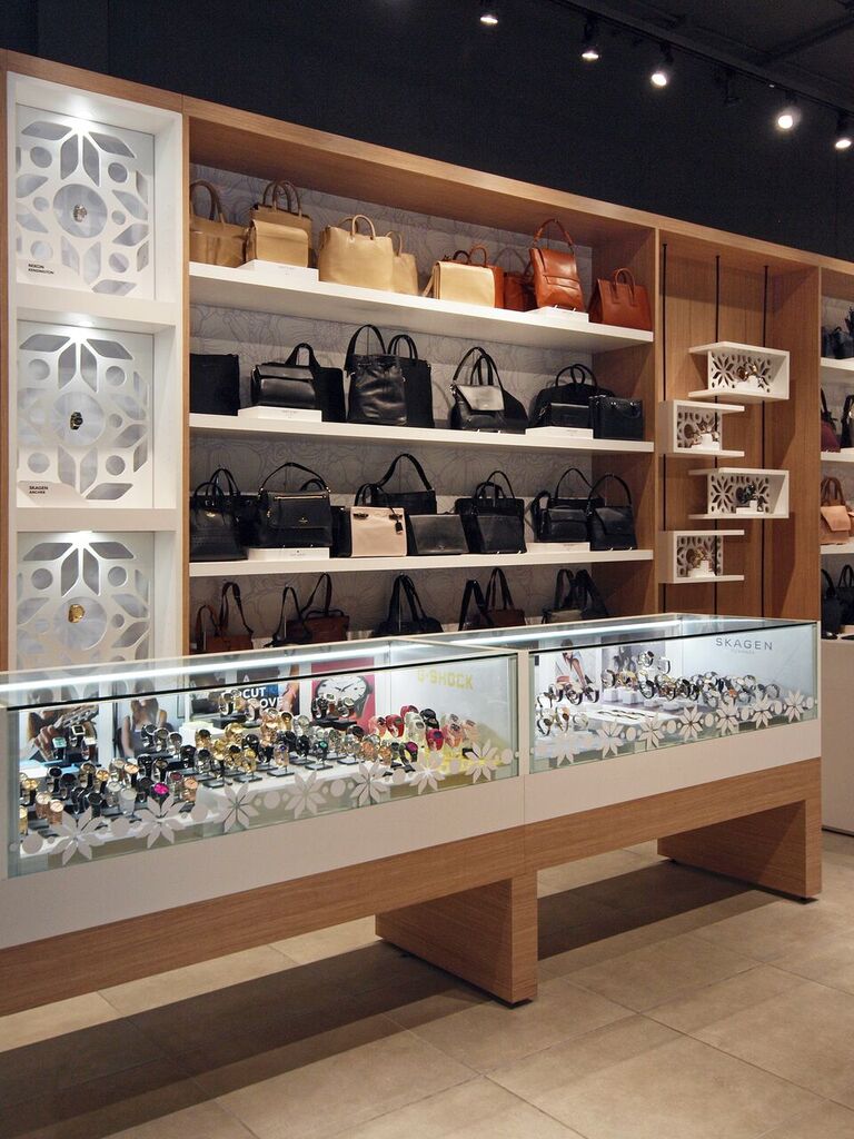 Wall and glass counter displays for leather goods and watches. Photo: Peregrine.Build
