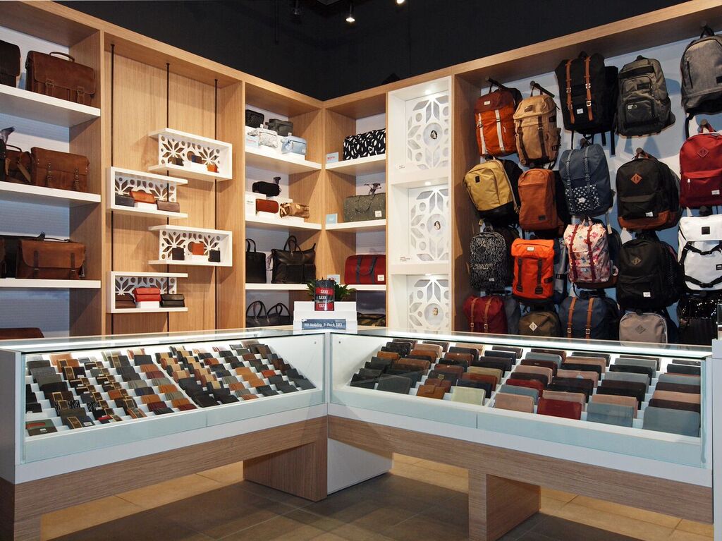 Backpacks, wallets and other product displayed on walls and in glass-enclosed cases. Photo: Peregrine.Build