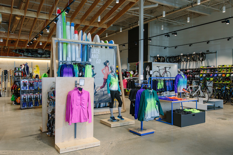 Displays at the entrance to the store feature athletic wear as well as a wood 'canoe rack' in Canadian maple plywood. 