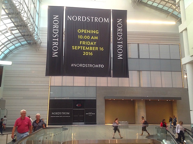 May 26, 2016. Hoarding was recently removed at CF Toronto Eaton Centre, revealing two store entrances and the facade for 'Ebar', covered in black. Photo: Craig Patterson for Retail Insider.