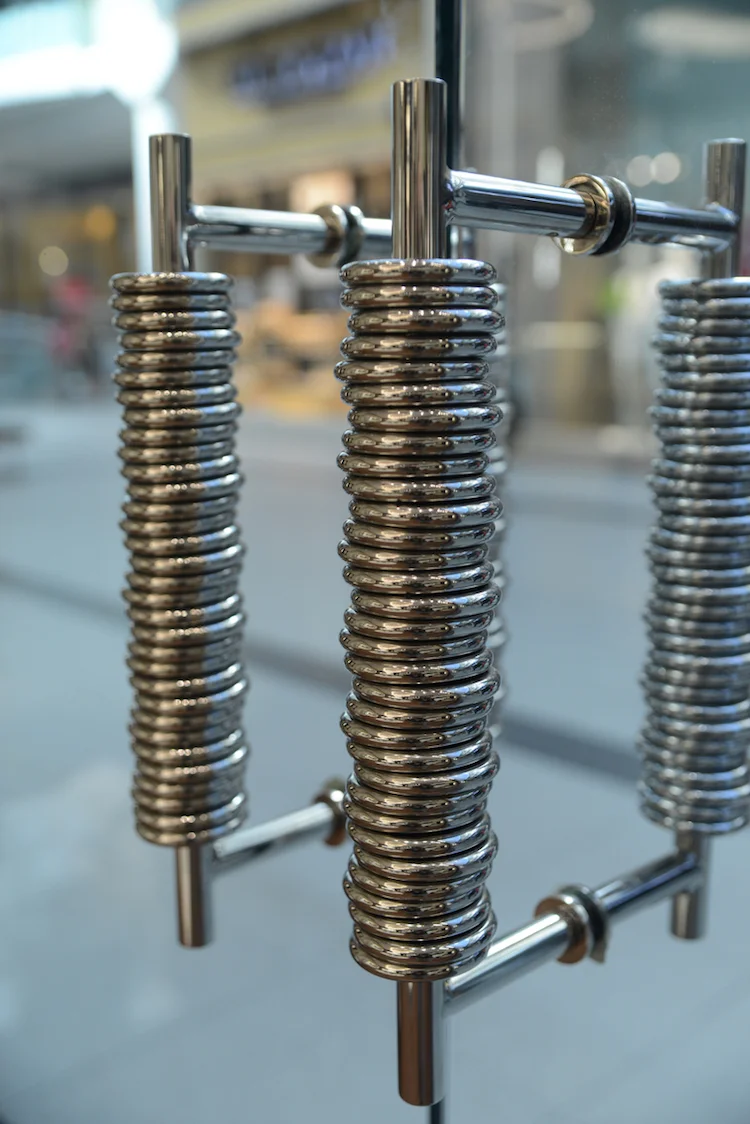 Jewellery inspired door handles at the front of the store. Photo: Tom Sandler
