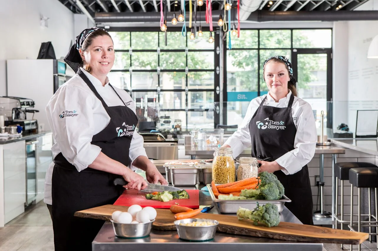 Chefs prepare food in Tom & Sawyer's open kitchen