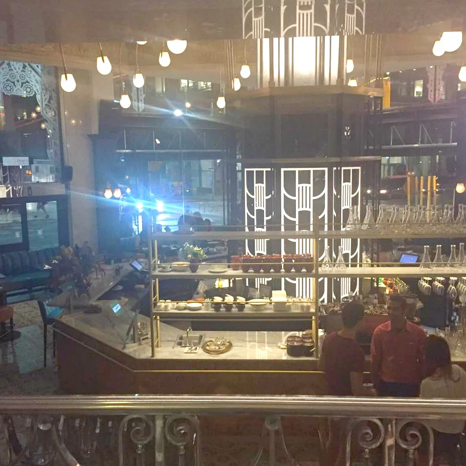 Looking down to the street level bar from a railing 1/2 floor above (same level as Saks' ground floor accessories/beauty) Photo: Chef Julie Marteleira