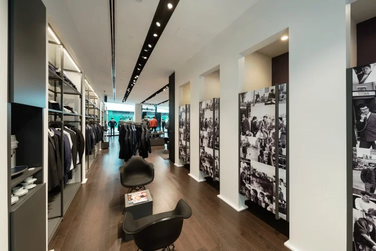 Dressing room area at the back of the store includes seating as well as coffee. 
