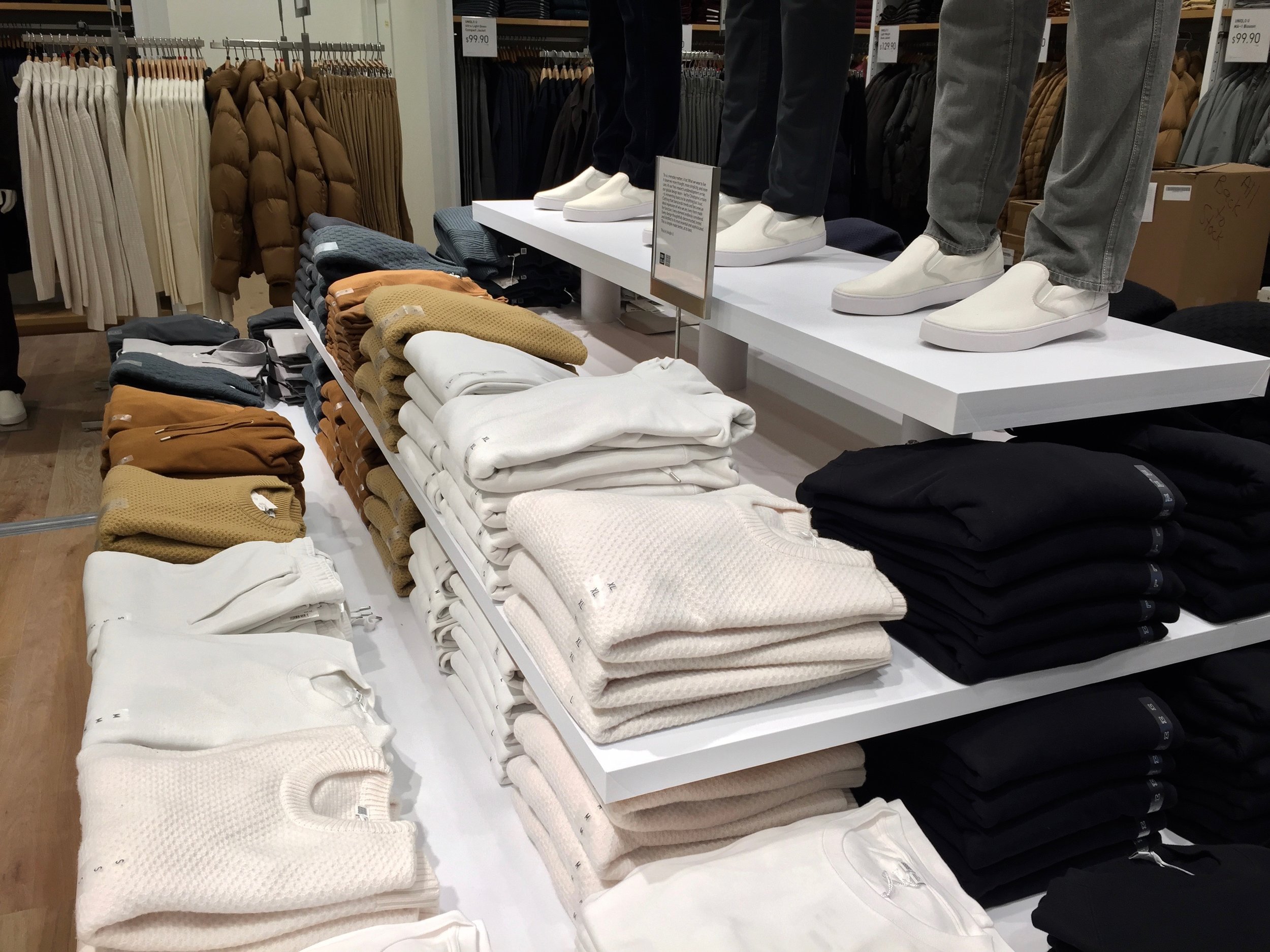 Men's sweaters from the 'Uniqlo U' clothing line sit on the second floor display table. Photo: Devon Johnson