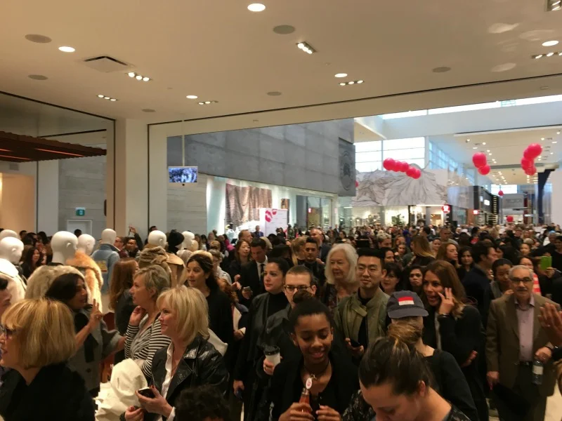 (Shoppers enter the new store, with staff clapping to welcome them)&nbsp;