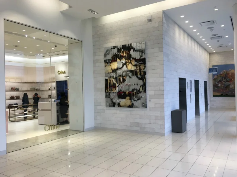 (Elevator banks bathed in natural light, next to the ground-level Chloé accessories boutique)&nbsp;