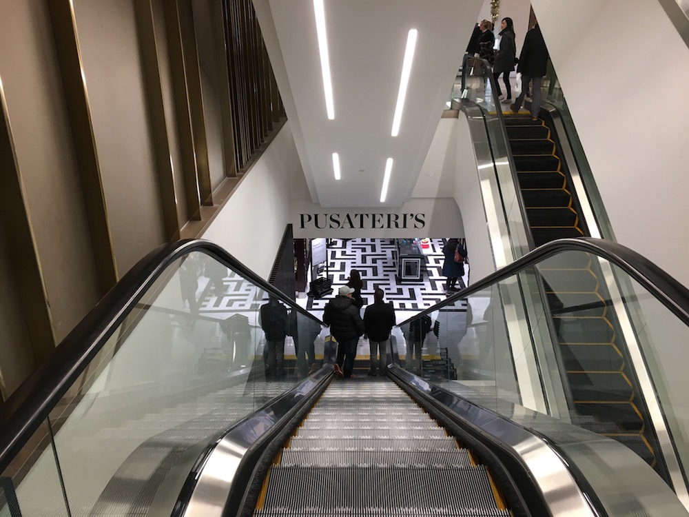 (Standing on Saks Fifth Avenue's ground floor, looking down the escalator towards the concourse-level Saks Food Hall by Pusateri's) 