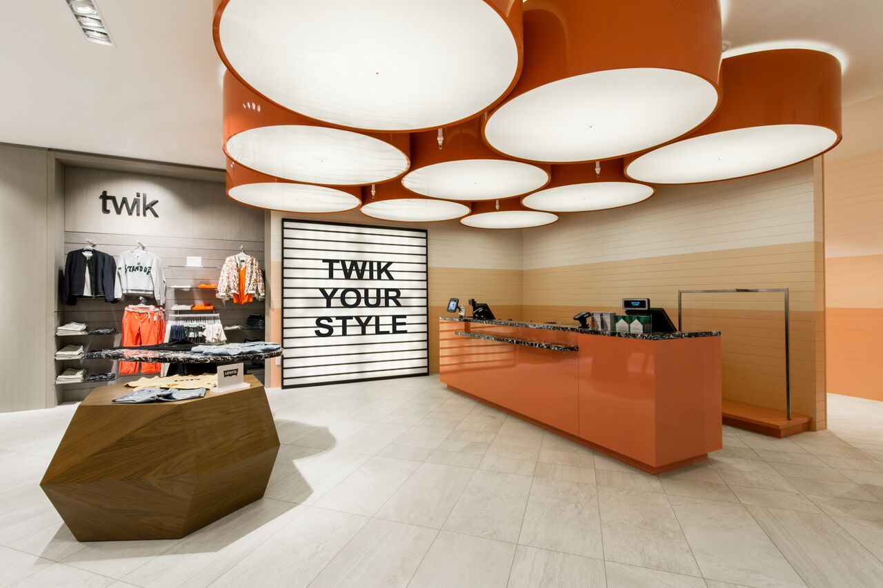 (Twik &nbsp;department for young female shoppers, decorated in pinks and peaches with decorative panels of weaving and a large vintage inspired billboard sign,)