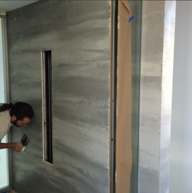 (Applying a tricolor Venetian plaster finish to a glass elevator.&nbsp;Photo: Darrell Morrison