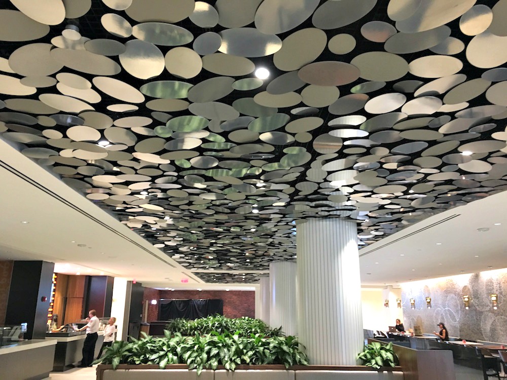(plants, eye-catching reflections and varied materials create a warm atmosphere at Yorkville village's food hall in Toronto. photo: craig Patterson)