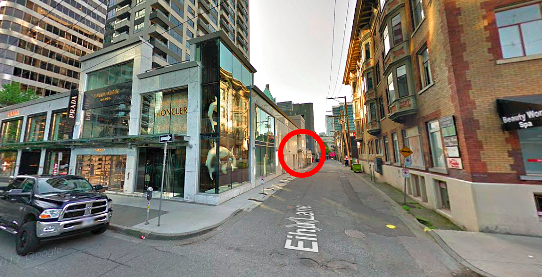 [Looking east down 'Eihu Lane' from Thurlow Street Towards Burrard Street. Image by Google Street View. 'The Carlyle' retail complex is to the left housing Moncler, Saint Laurent, prada and other luxury brands and to the right is the historic residential 'manhattan building']