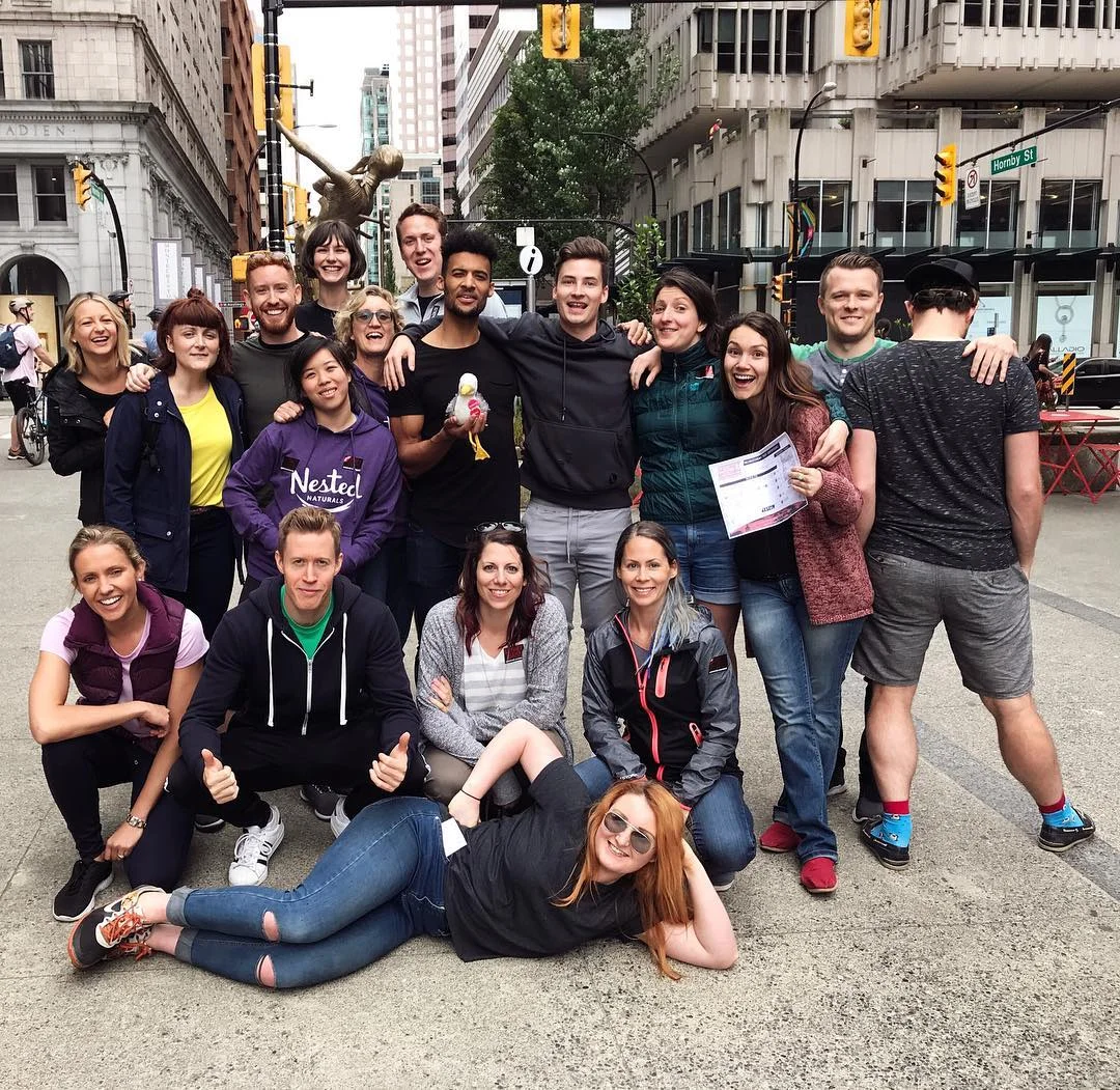 The team from Nested Naturals pose for a photo at the corner of West Hastings Street and Hornby Street in Downtown Vancouver 