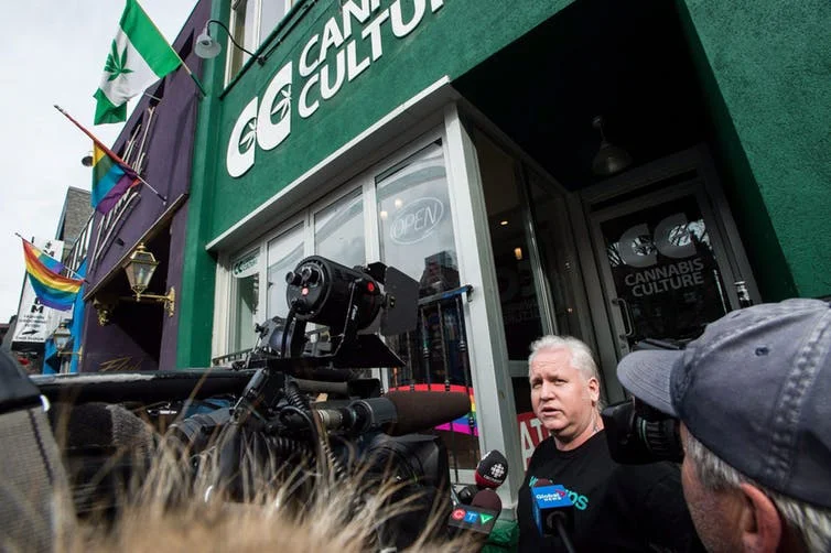 Stores in Ontario currently selling cannabis illegally will need to shut down before Oct. 17 and they apply for a legal retail licence. In this photo from March 2017, store manager Mark Harrison speaks to media outside a Cannabis Culture store following a police raid in Toronto on Thursday, March 9, 2017. THE CANADIAN PRESS/Aaron Vincent Elkaim