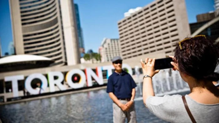 taking-a-photo-in-front-of-toronto-sign.jpg