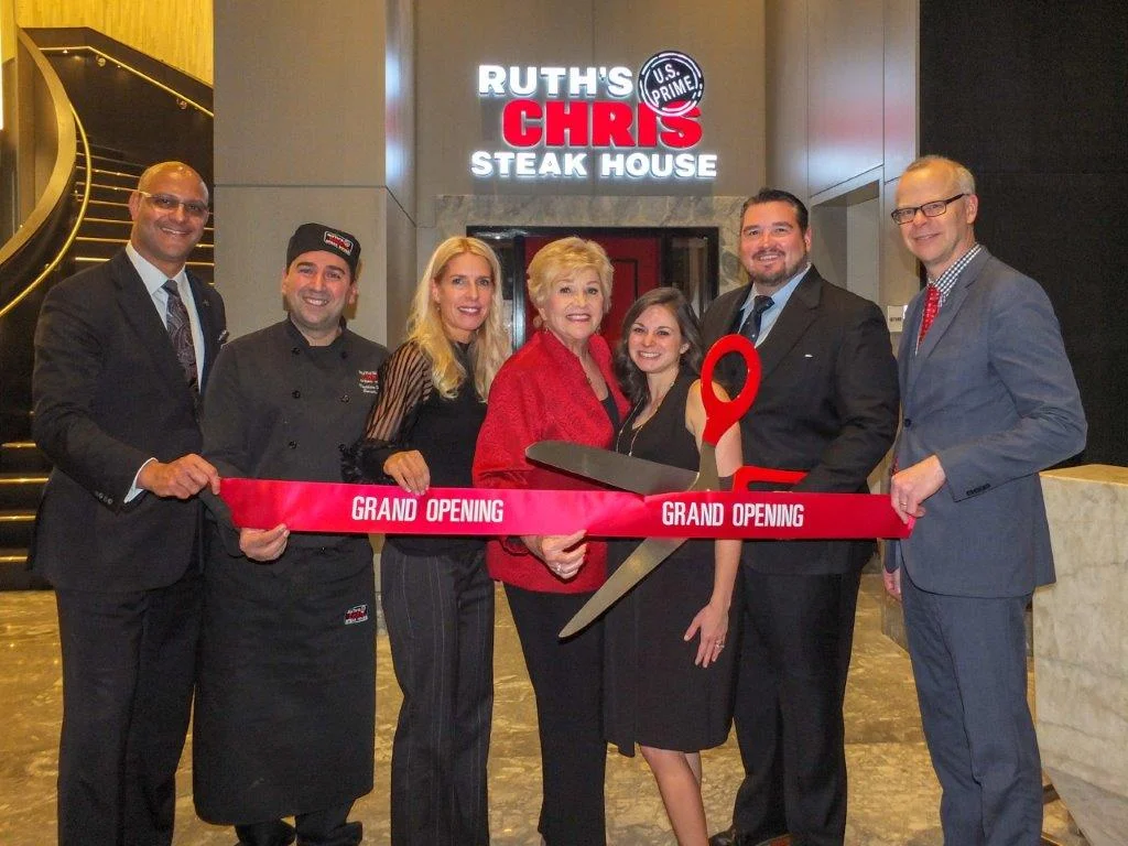 Co-Franchisees Lana Duke and R. David Duke marked the Grand Opening of their third Ruth’s Chris Steak House in the GTA, located in the Marriott Markham Hotel at 170 Enterprise Blvd in ‘Downtown Markham. Joining in the ribbon cutting festivities (right to left) Ruth’s Chris-Markham General Manager Mike Berlanguet, R. David Duke, Lori Duke, Lana Duke, Director of Sales &amp; Marketing Sara Wilde, Executive Chef Ibrahim Hodroj and Toronto Marriott Markham General Manager Hiren Prabhakar. (Photo: Darrell Hein)