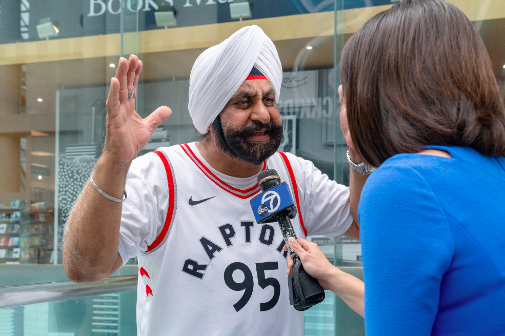 Raptors superfan Nav Bhatia speaks to a reporter.