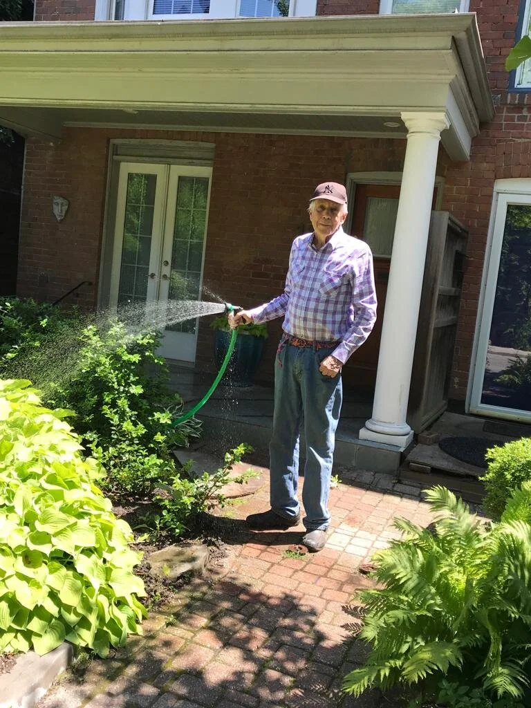 A photo of John Williams in the garden of his home in Toronto’s Riverdale area