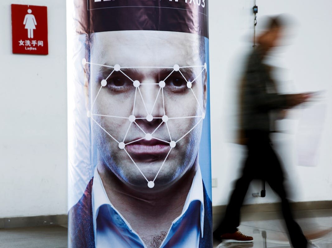 a poster simulating facial-recognition software at the Security China 2018 exhibition on public safety and security in Beijing, China. PHOTO: BUSINESS INSIDER
