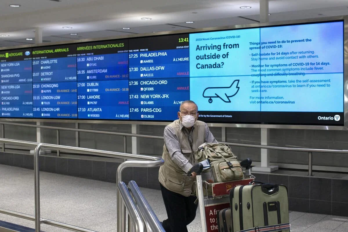A traveller arrives on an international flight at Toronto’s Pearson Airport in March 2020 after the COVID-19 pandemic was declared. THE CANADIAN PRESS/Chris Young