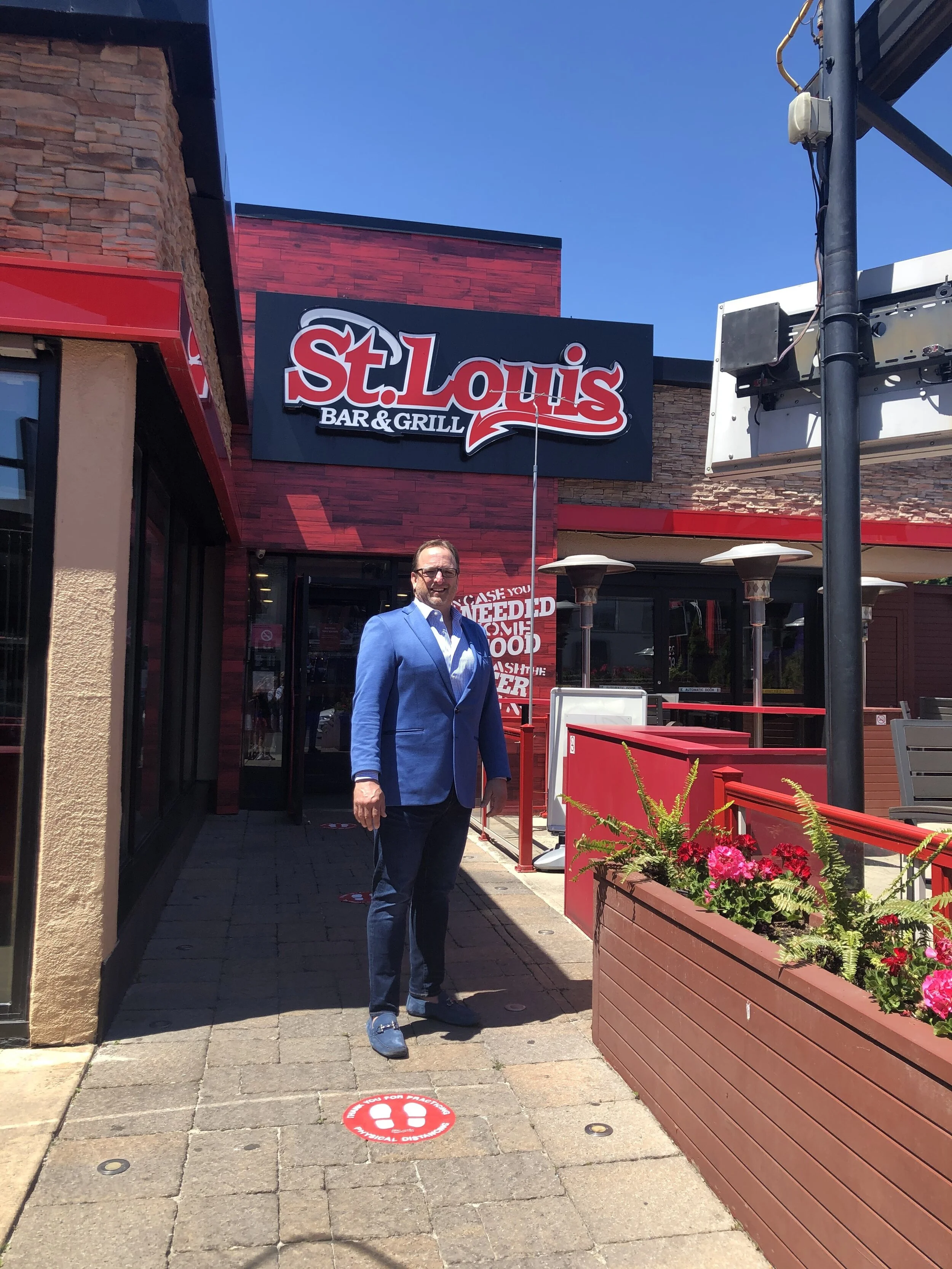   BRENT POULTON STANDING OUTSIDE ST. LOUIS BAR AND GRILL. PHOTO: ST. LOUIS  