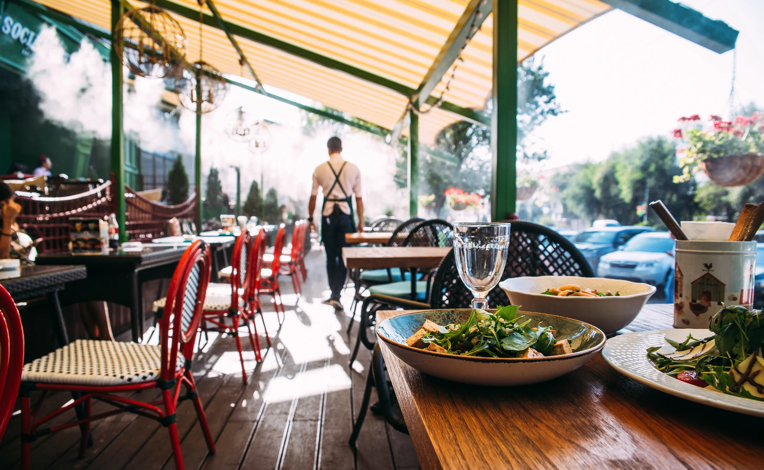 waiter walking amongst tables in a quiet restaurant
