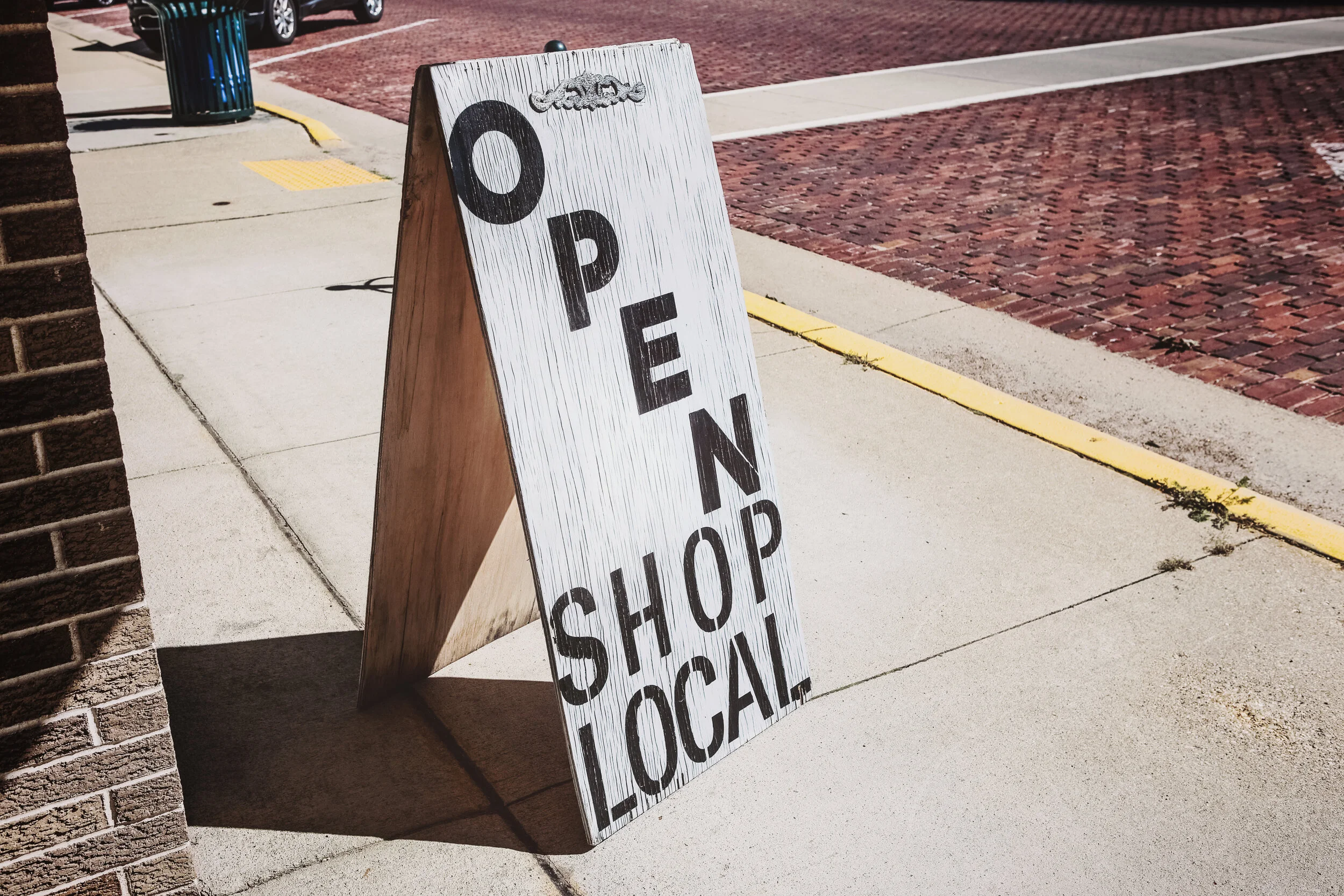shop local sandwich board outside store.