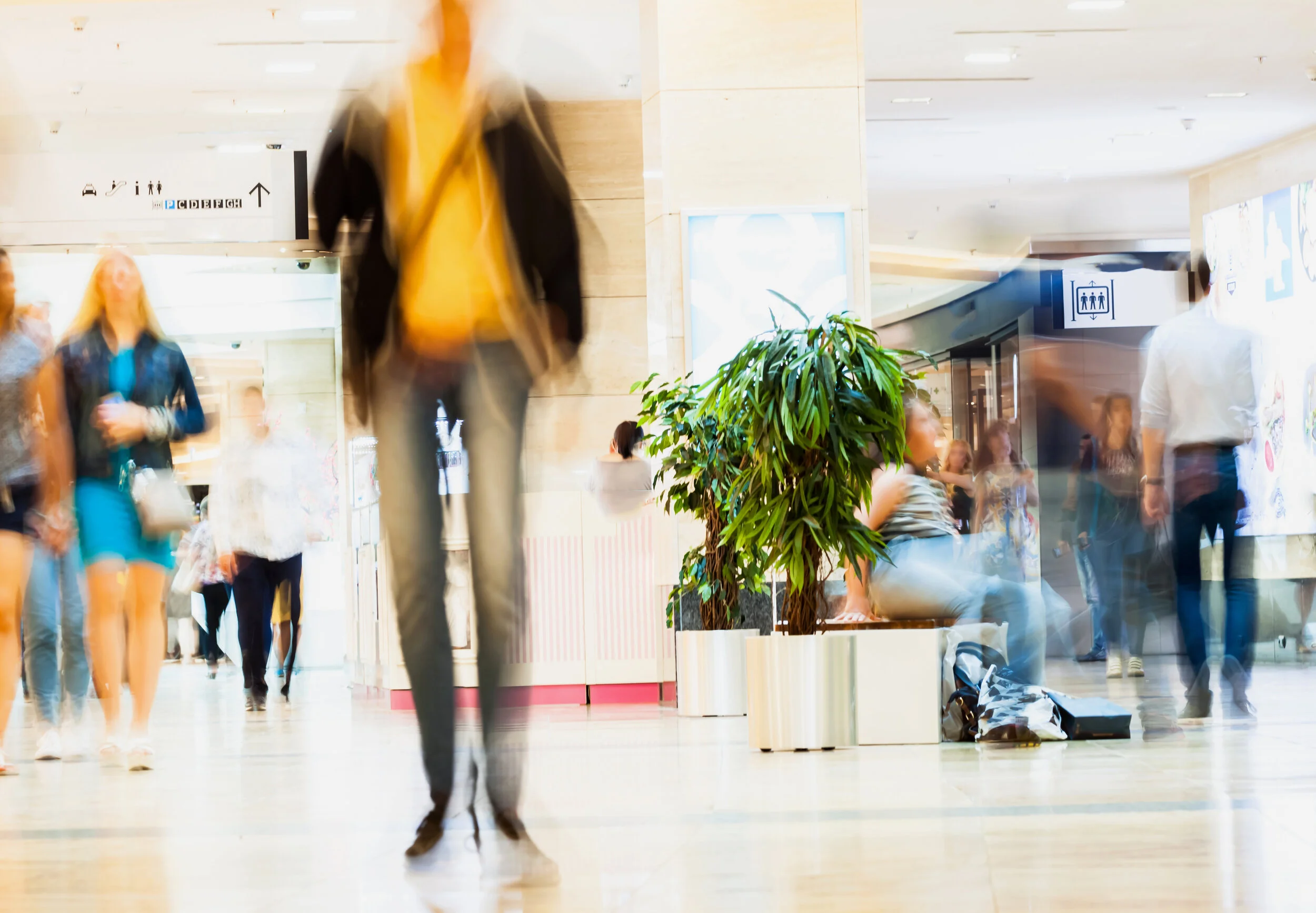 image of blurred shopper inside mall