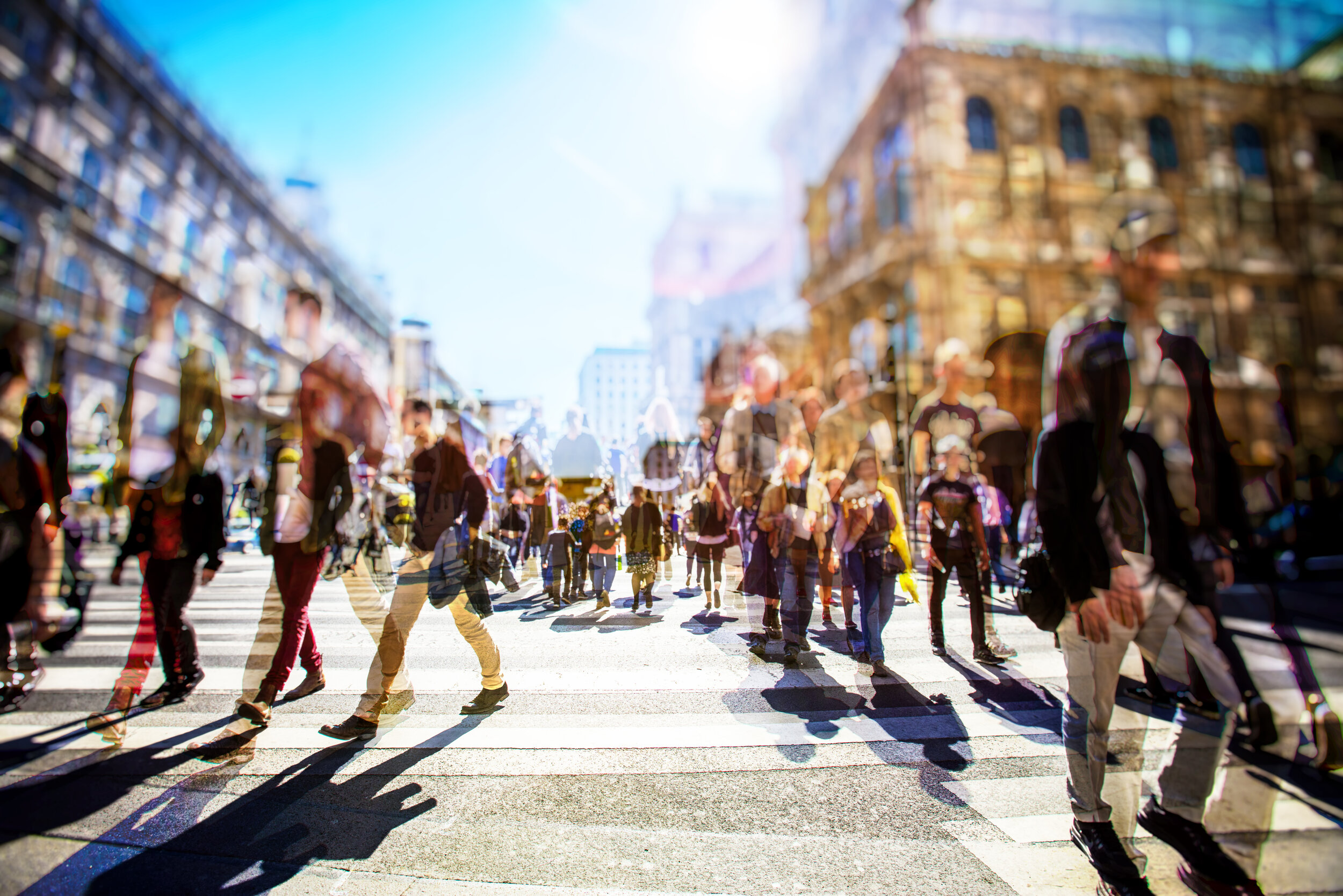 blurred image of shoppers moving in different directions at intersection