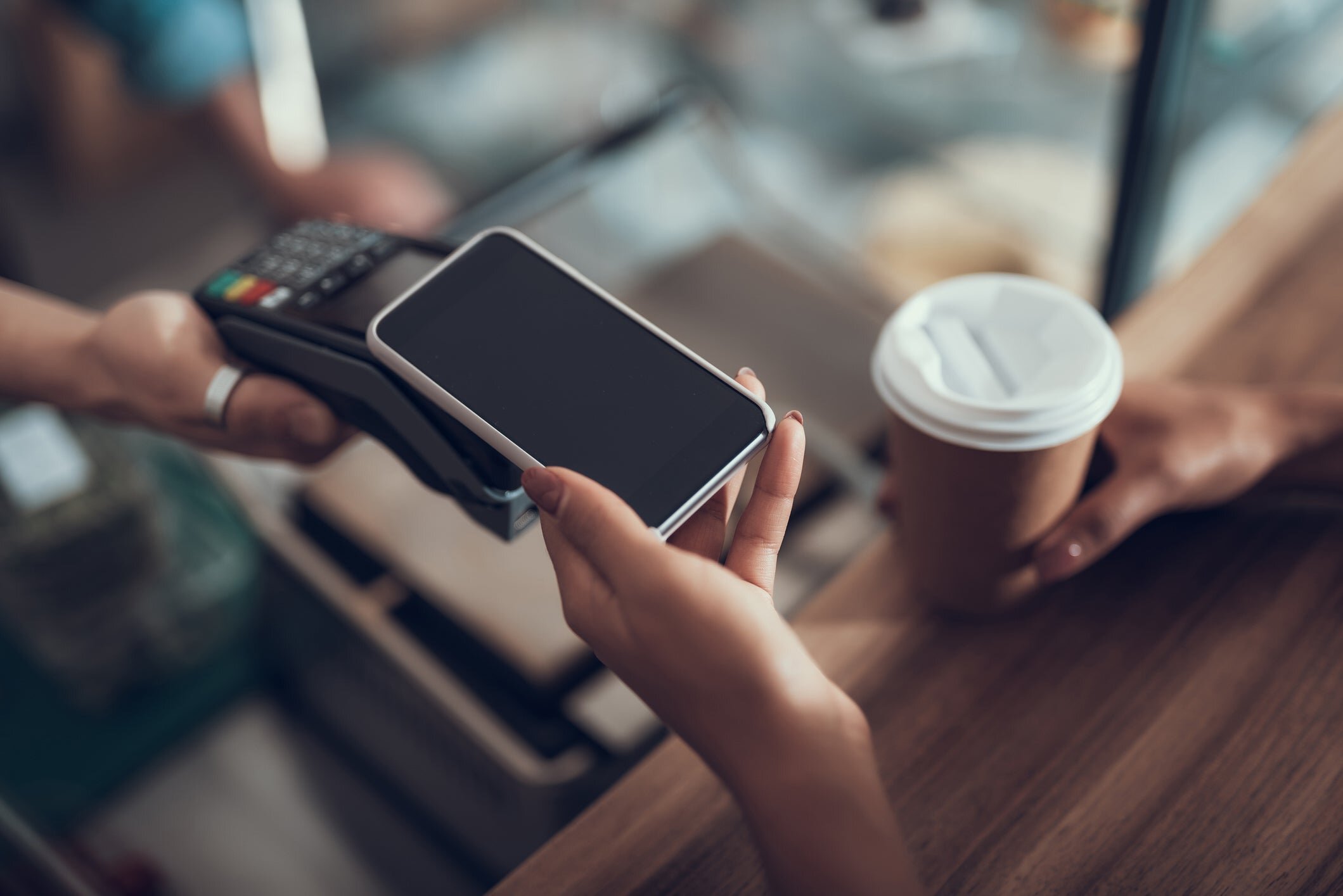 patron paying for coffe with contactless payment method