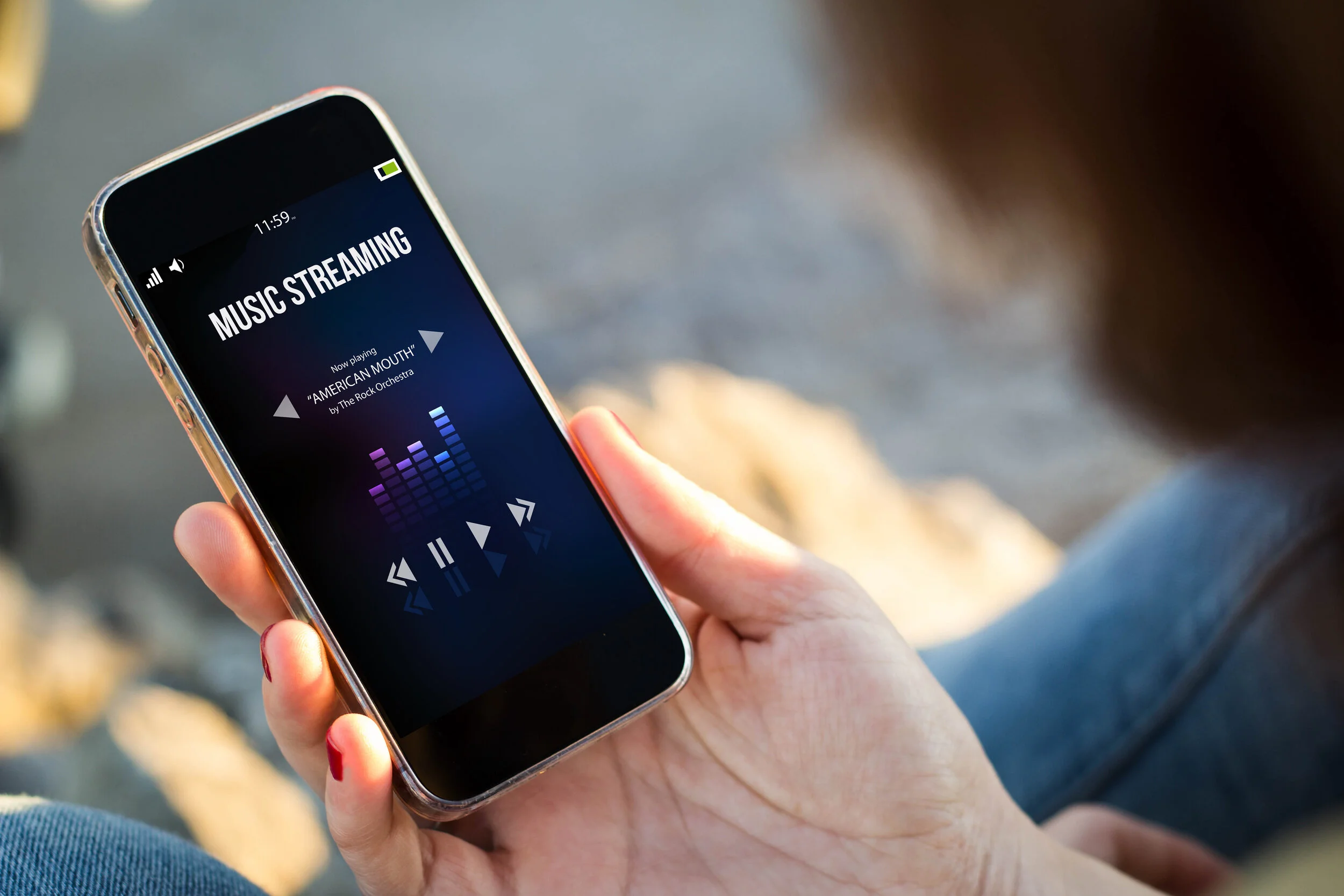 woman streaming music on smartphone