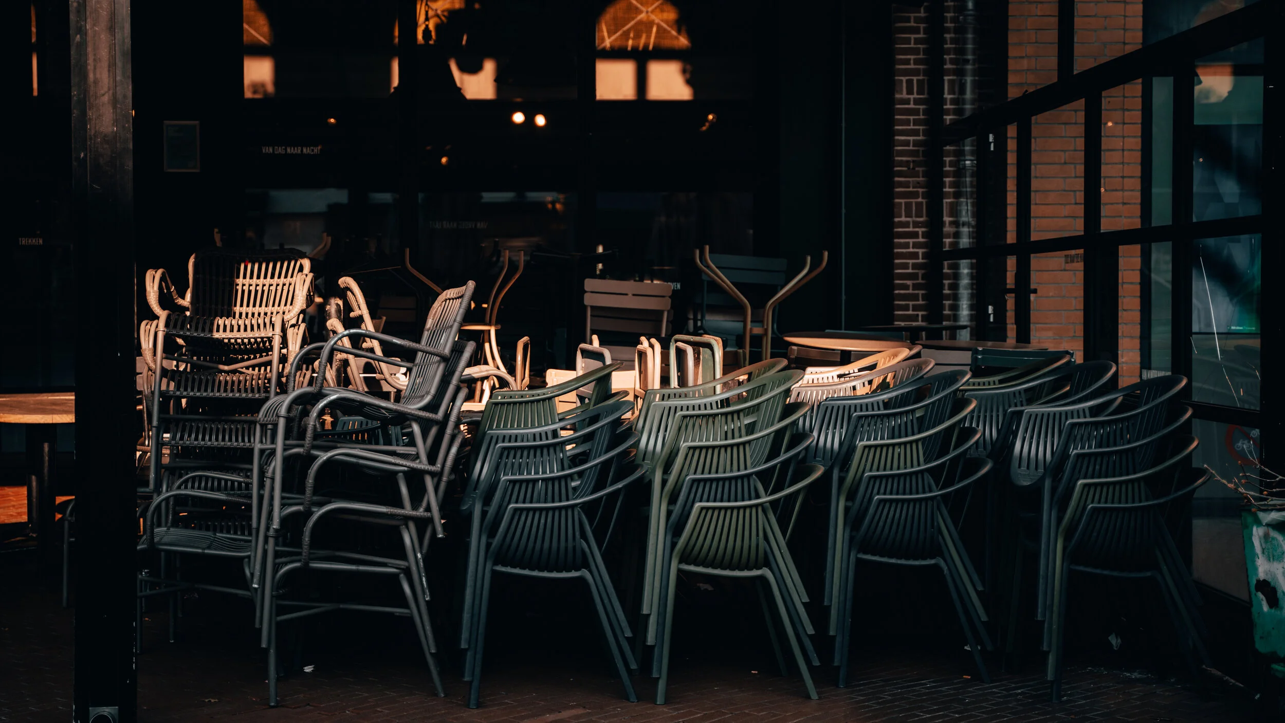 stackced chairs outside cosed restaurant