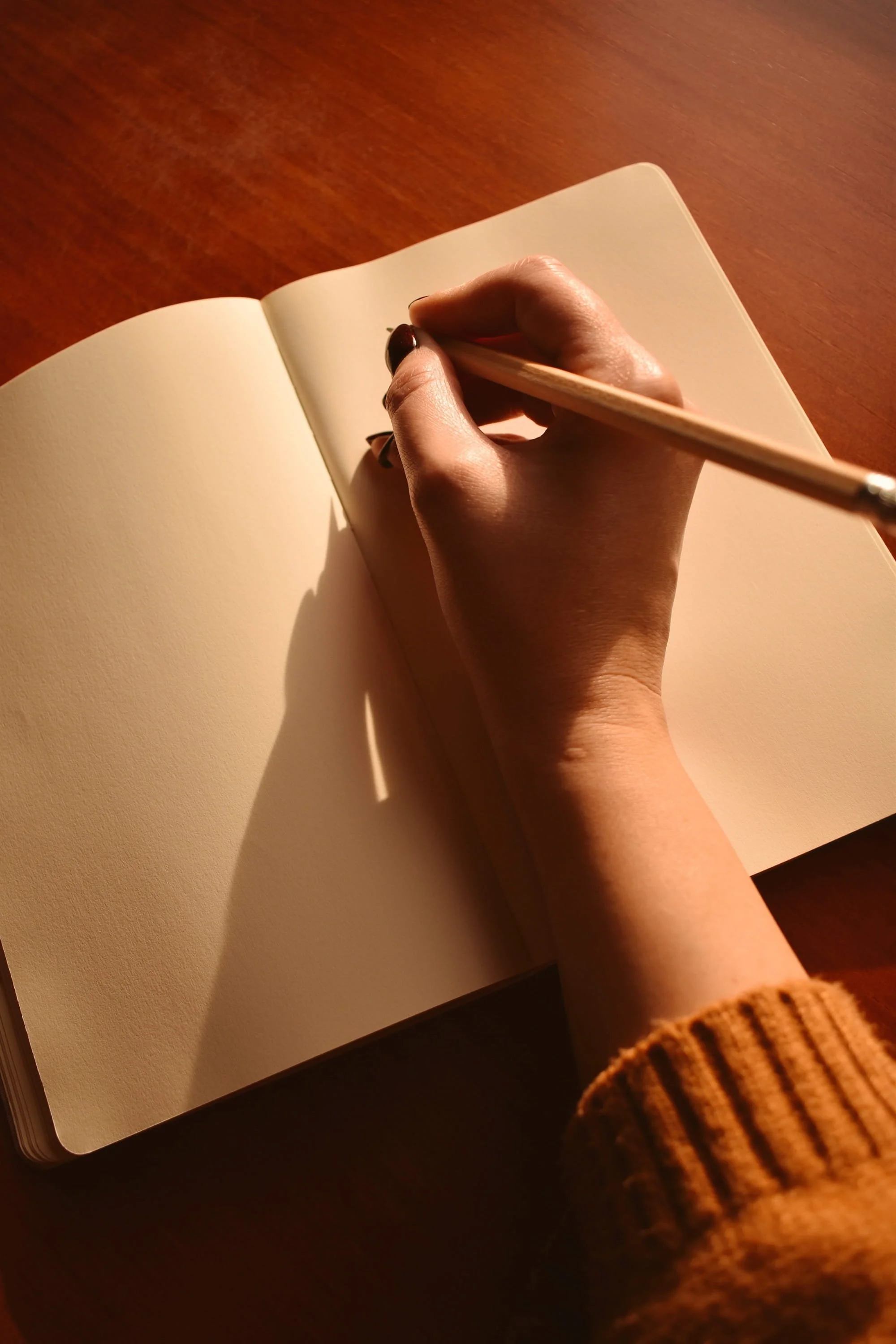 The Index Blog Cover Photo of woman's hand writing in a journal