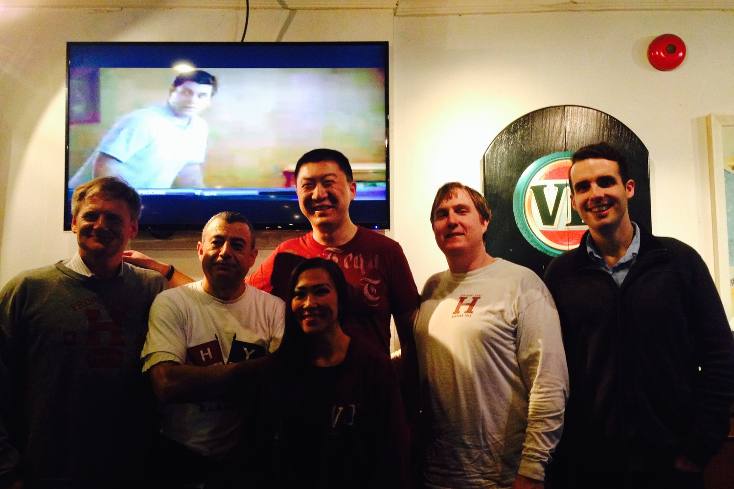 Harvard alums basking in victory at the Camel Sports Bar in Shanghai.