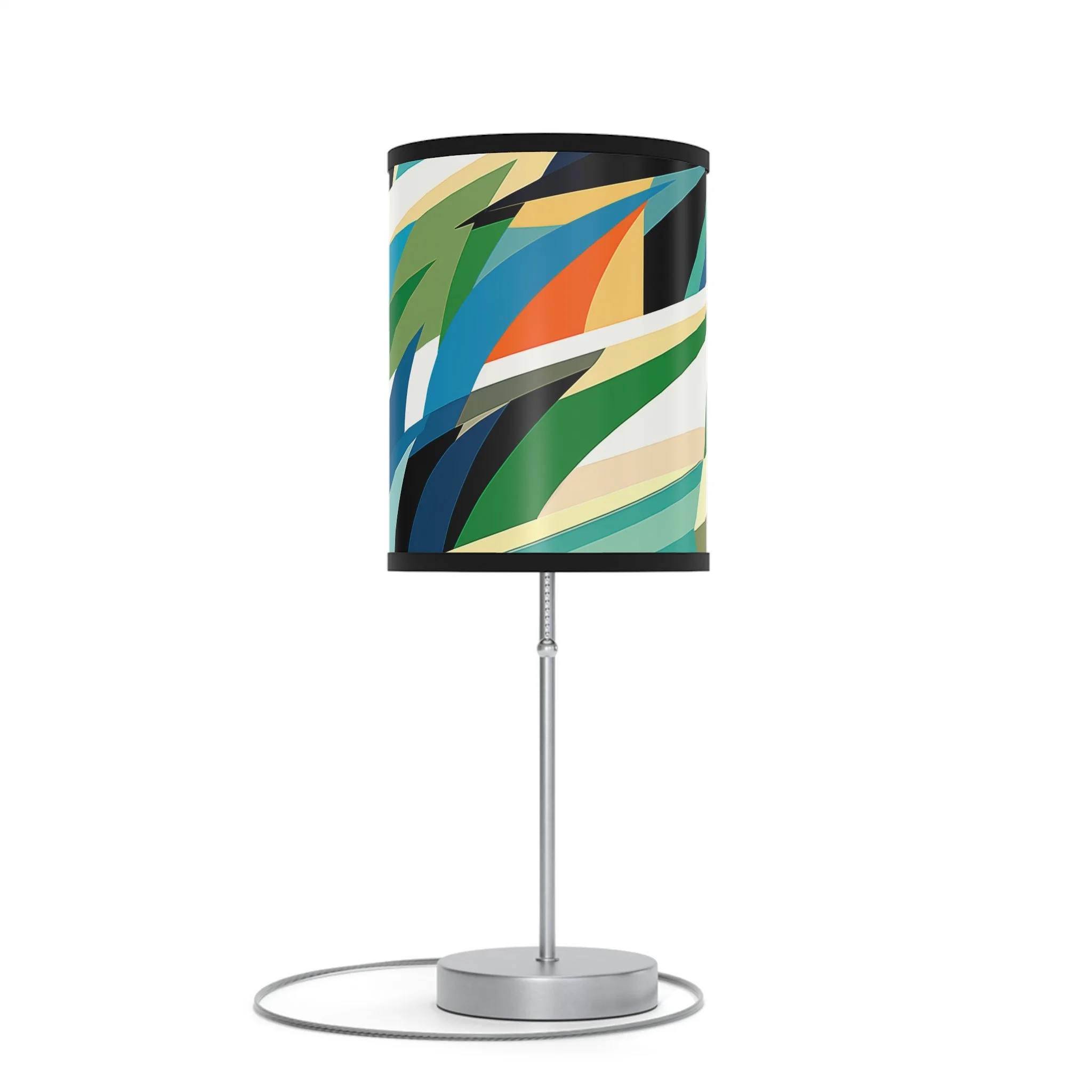 Table lamp with a black top and a colorful abstract pattern on the shade, standing on a round silver base with a slender stem and an attached cord.