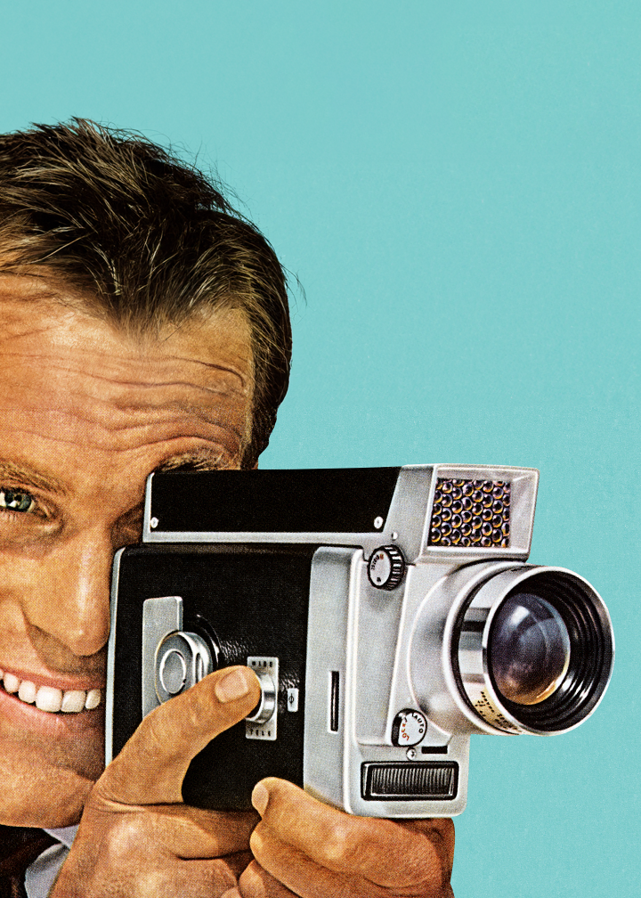 Vintage image of a man with a home movie camera against a robin's egg blue backdrop.