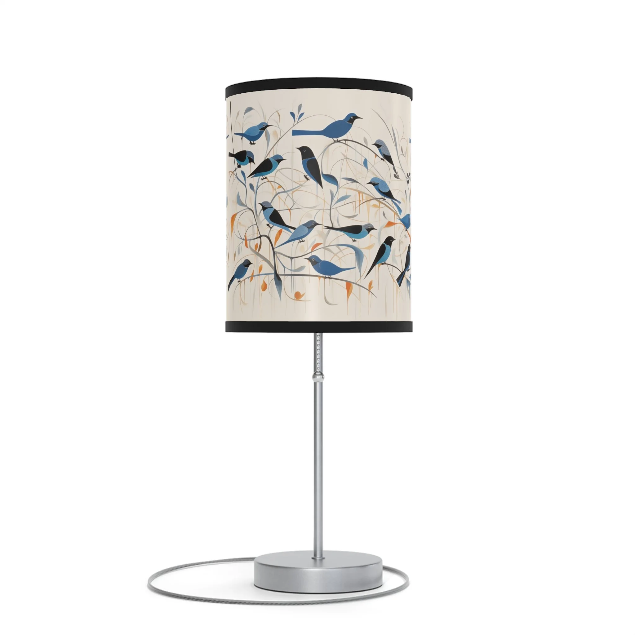Table lamp with a lampshade decorated with a bird and nature motif, featuring blue and black birds on branches.
